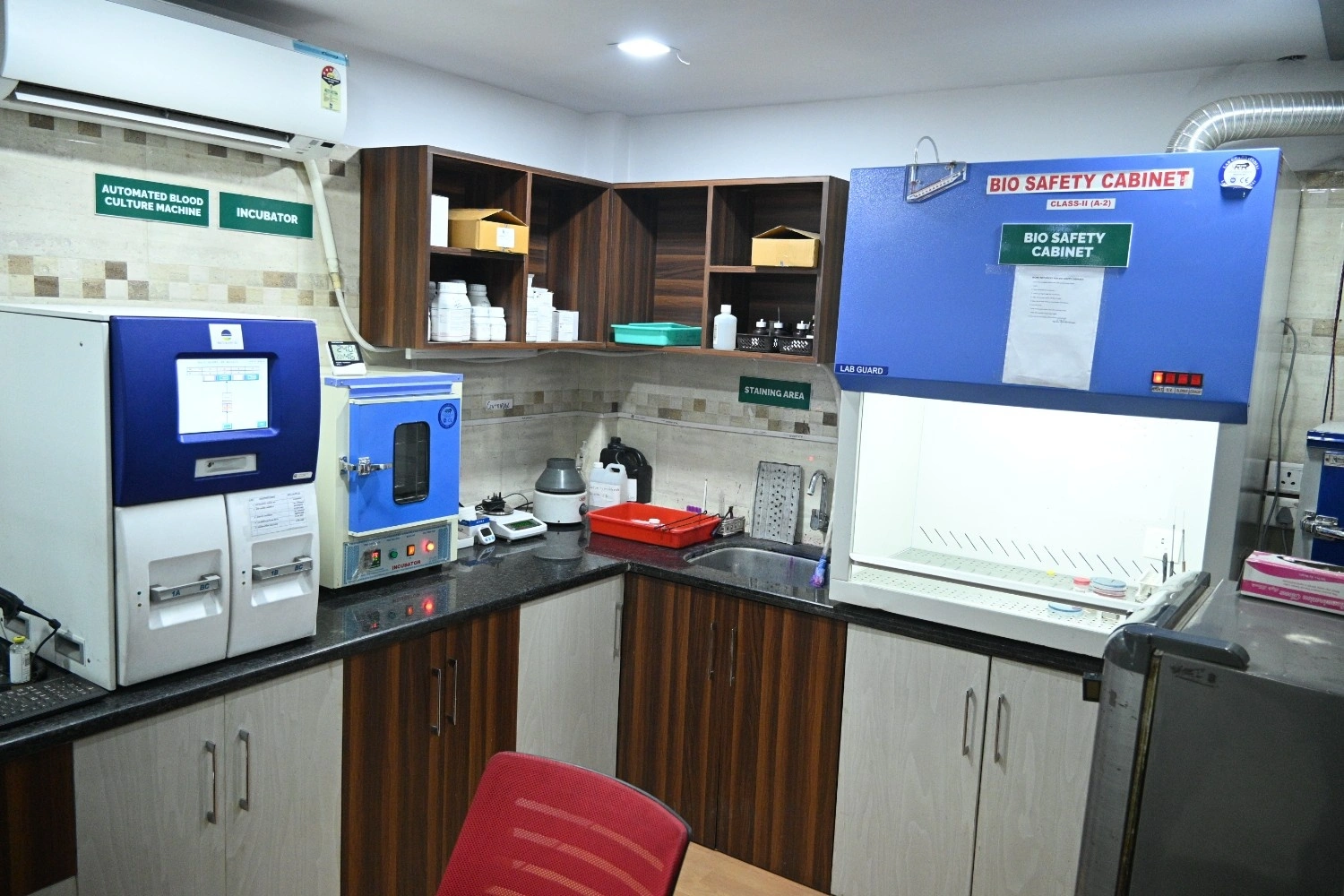 Sterile laboratory workstation with incubator and bio-safety equipment for pathology testing.